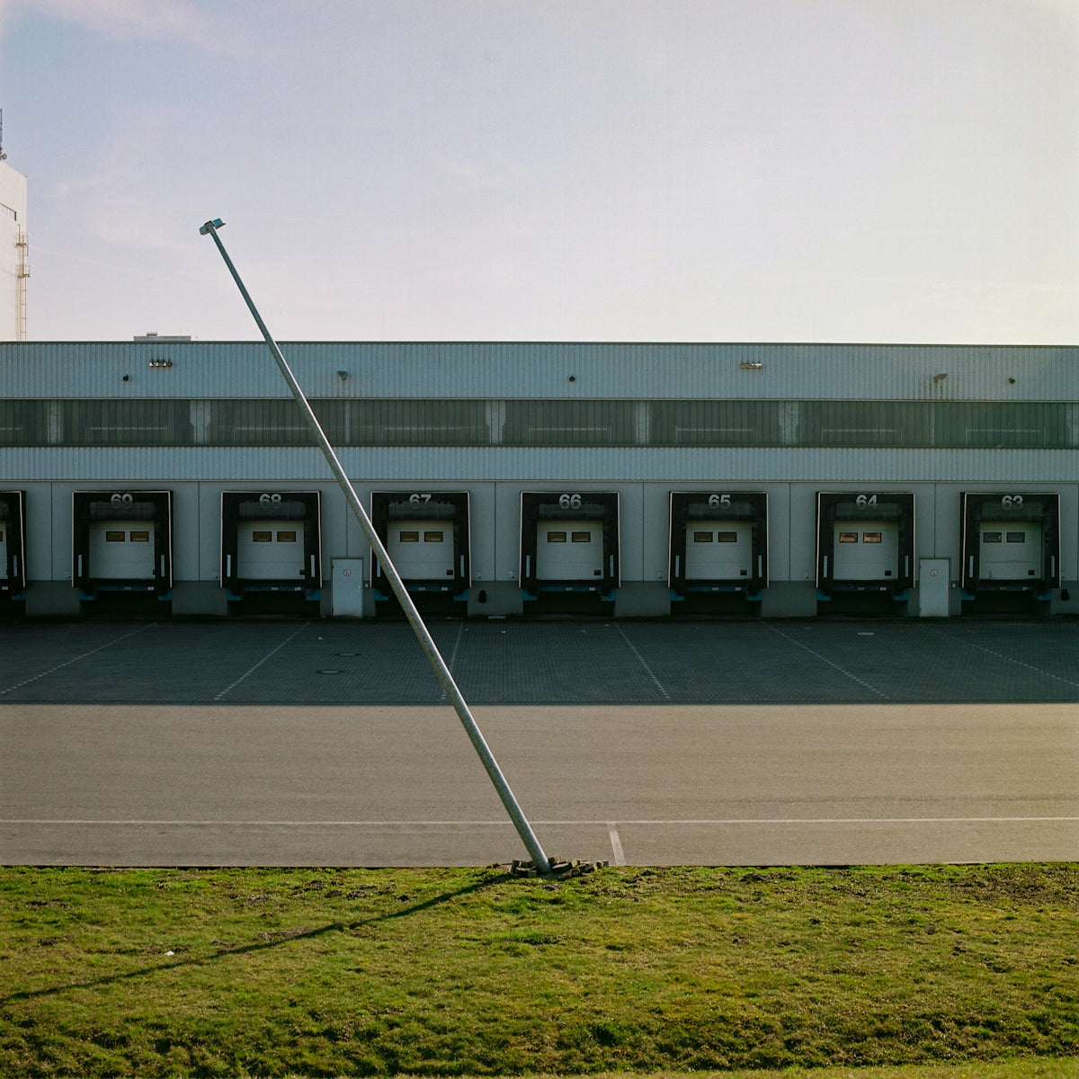 white and gray building with green grass field